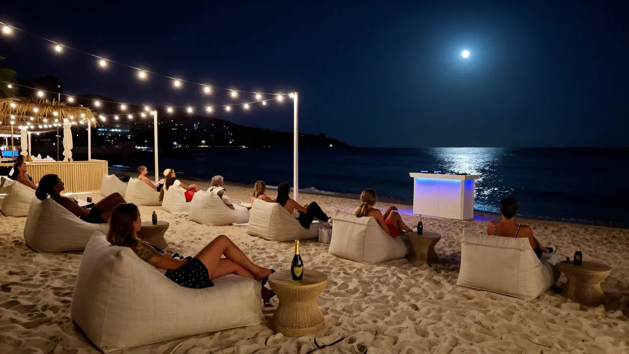 Elegant guests relaxing on white sand under string lights by the Mediterranean at night.